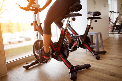 woman riding stationary bike in a gym