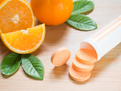 vitamin C effervescent tablets next to oranges
