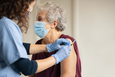 older woman receiving COVID-19 vaccine