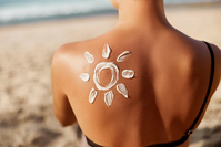 sunscreen in shape of sun on woman's back