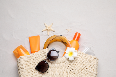 beach bag with sunglasses and sunscreen products